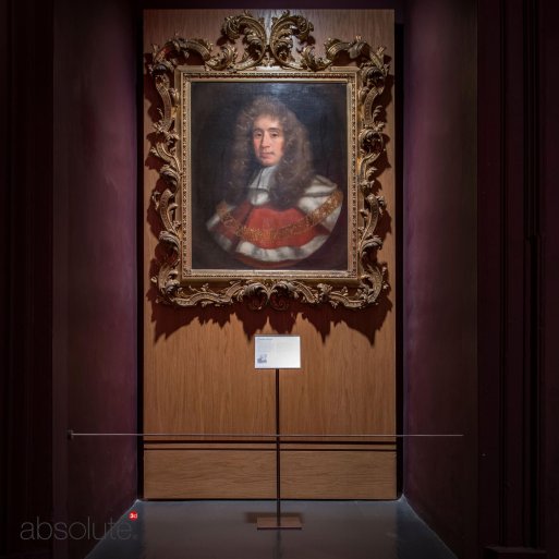 Pinnacle label holder displaying information for an old artwork in a detailed, engraved frame. Pinnacle label holder displaying information for an old artwork in a detailed, engraved frame.